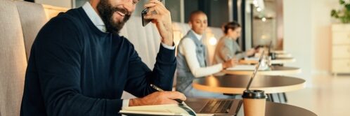 Happy,Businessman,Making,Notes,During,A,Phone,Call.,Young,Businessman