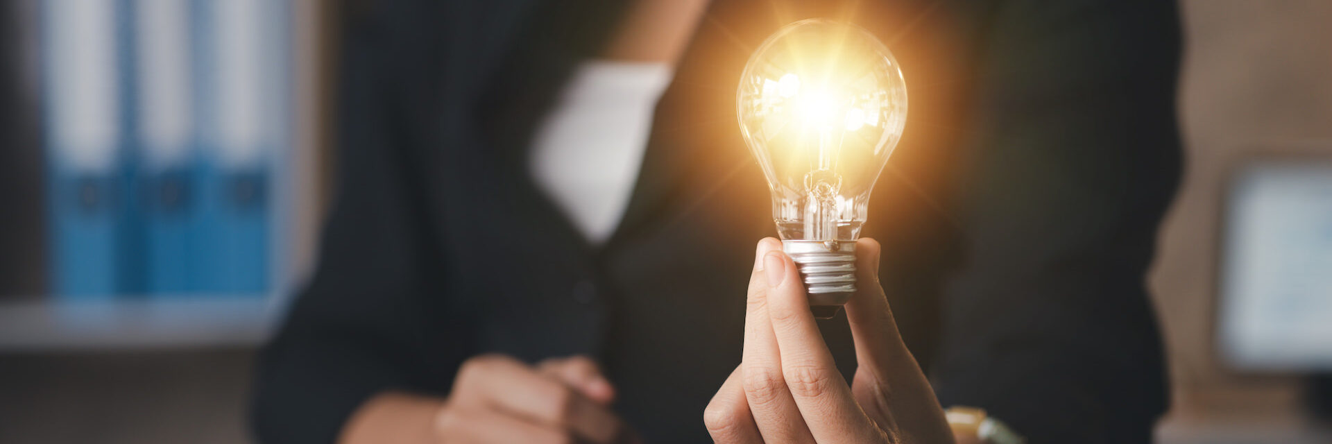 Person hold glowing light bulb, Creative new idea. Innovation, brainstorming, strategizing to make the business grow and be profitable. Concept execution, strategy planning and profit management