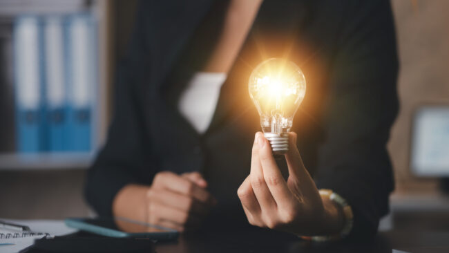 Person hold glowing light bulb, Creative new idea. Innovation, brainstorming, strategizing to make the business grow and be profitable. Concept execution, strategy planning and profit management